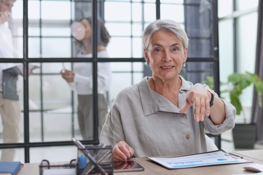 Modern mature businesswoman working at her desk