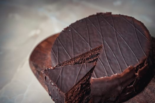 Round chocolate cake with triangular slice cut off. High quality photo