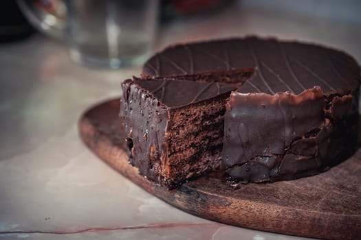 Round chocolate cake with triangular slice cut off. High quality photo