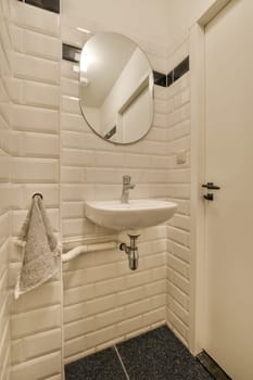 a bathroom with a mirror above the sink and towel rack on the wall next to the shower stall is white