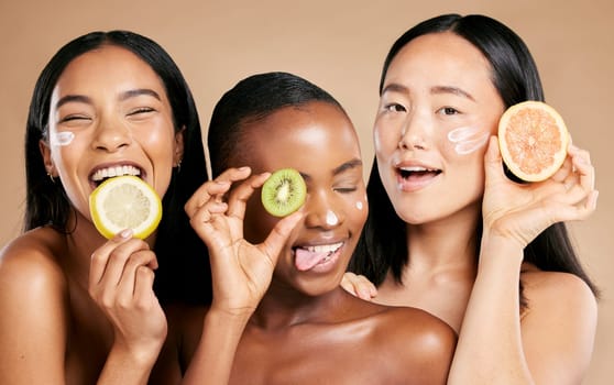 Face, fruit and women in portrait with cream for facial care, beauty and natural cosmetics isolated on studio background. Sunscreen, vegan and different skin with skincare, moisturizer and playful.