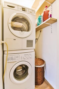 a white washer and dryer in a laundry room with wood flooring on the walls, next to a basket full of