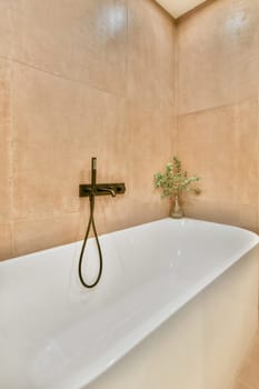 a white bathtub in the corner of a bathroom with a plant on it's side and an open window