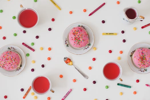 Cup of coffee and pink doughnuts on the white background.