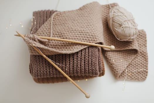 Close-up of wool and needles for knitting on the table