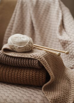 Close-up of wool and needles for knitting on the table