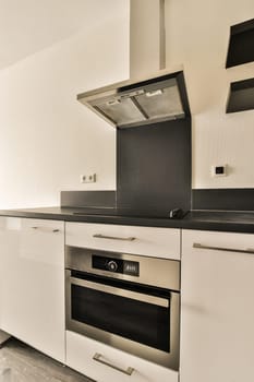 a modern kitchen with white cabinets and black counter tops on the stoves, which is also used as an appliance