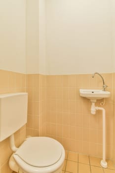 a white toilet and sink in a small bathroom with tile on the floor, walls and ceiling is painted beige