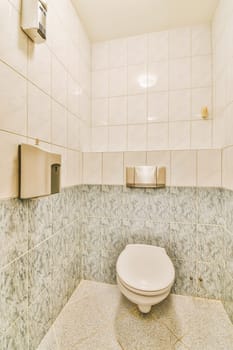 a white toilet in a bathroom with tile on the walls and flooring around it's edge, as seen from above