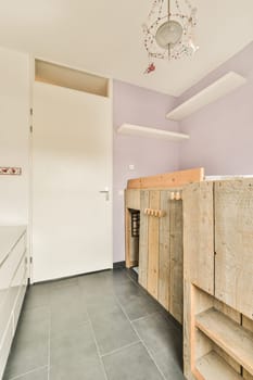 a kitchen with purple walls and white cabinets in the back ground, there is a light fixture on the ceiling