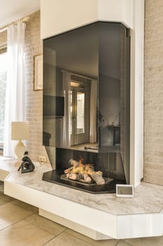 a living room with a fireplace in the middle and a large mirror on the wall above it that has been painted white