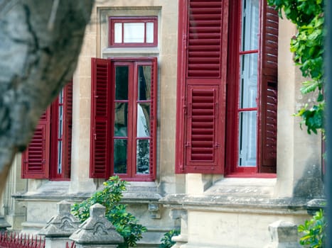 Fragment of the building's facade with traditional wooden ornate balconies painted in Valletta, Malta. High quality photo