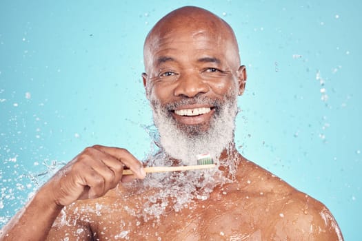 Water splash, toothbrush and portrait of black man with smile on face, mockup isolated on blue background. Teeth, toothpaste and product placement, senior dental care and cleaning mouth in studio.