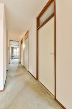 an empty room with white walls and wood trim on the door, carpeting is in front of the doorway