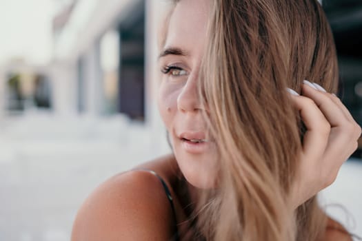 Happy woman portrait in cafe. Boho chic fashion style. Outdoor photo of young happy woman with long hair, sunny weather outdoors sitting in modern cafe