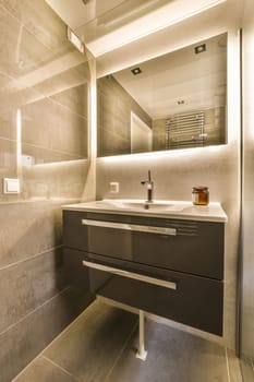 a bathroom with a sink and mirror on the wall next to it is an image of a toilet in the background