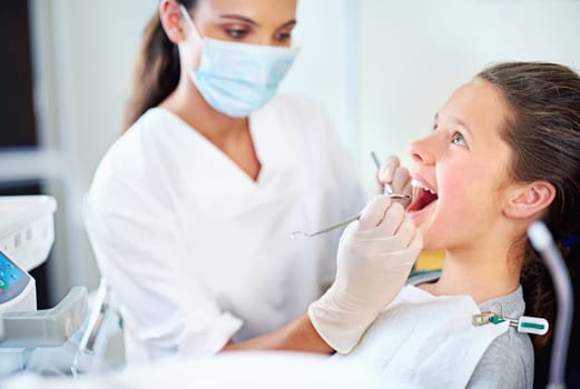 Just a quick clean. a young girl have a checkup at the dentist