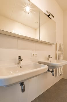 a bathroom with two sinks and a mirror on the wall above it that has been installed in an attic style home