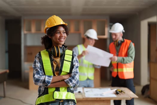 Foreman builder woman at construction site. American African foreman construction standing at construction site.