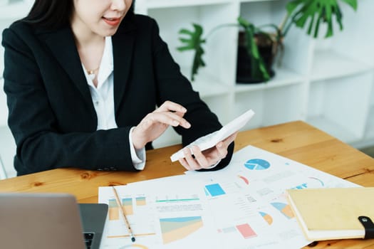 financial, Planning, Marketing and Accounting, portrait of Asian employee checking financial statements using documents and calculators at work..