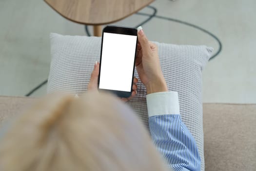 Young Asian women are using a white screen smartphone mobile that can add text or images to it.