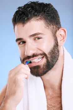 Brushing teeth, man and studio portrait of toothbrush for dental wellness, healthy lifestyle or mouth care. Happy face, male model and oral cleaning of fresh breath, smile and happiness on background.