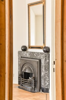a fireplace in a room with wood paneling and a mirror on the wall above it that has been painted white