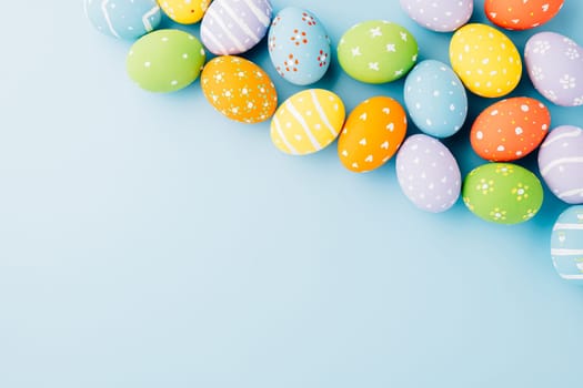 Colorful easter eggs isolated on blue background with copy space, Funny decoration, Creative composition banner web design holiday background, Happy Easter Day greeting card, flat lay top view