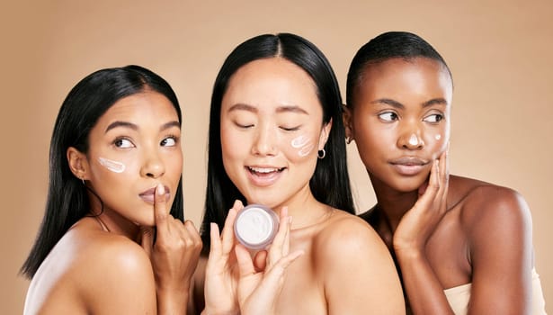 Skincare, women and face cream in studio for wellness, grooming and hygiene against brown background. Friends, beauty and lotion for girl group with different, facial and skin product while isolated.