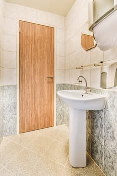 a bathroom with marble flooring and wooden paneled doors on the wall behind it is a white sink in front of a mirror