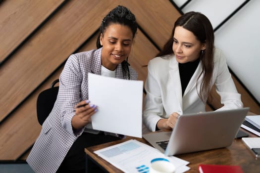 discussion between financial analysts women in the office.