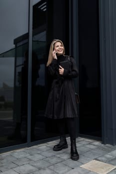 female financial agent stands at the door of the business center.