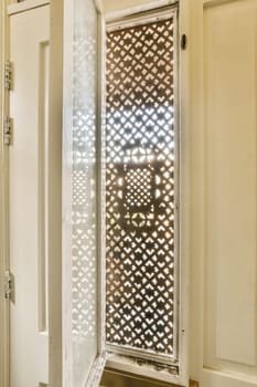 the inside of a bathroom with a shower stall in it's corner and an open door leading to another room