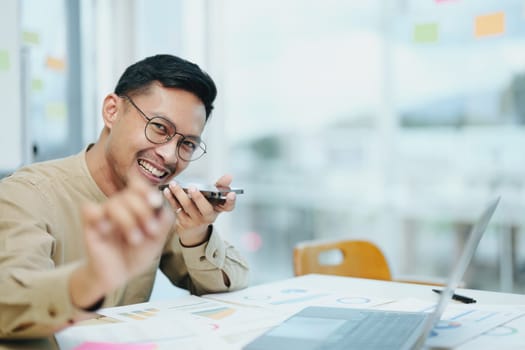 business owner or Asian male marketers are using business phones, calculator and computers to do office work.