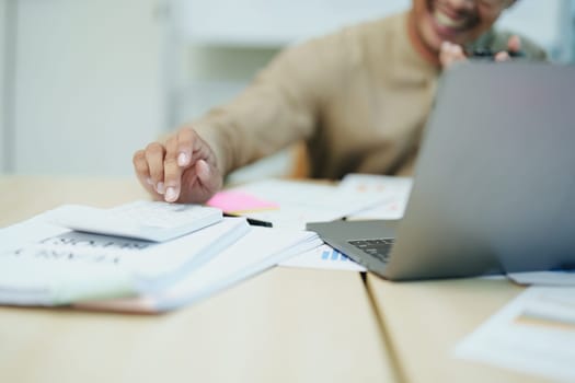 business owner or Asian male marketers are using business phones, calculator and computers to do office work.