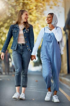 Friends, diversity and holding hands with women in road for support, spring and travel together. Community, happy and smile with girls walking in street path for muslim, social and solidarity.