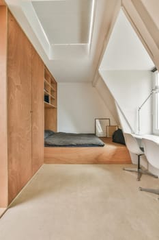 a room with a bed, desk and shelves on the wall next to an open door that leads to another room