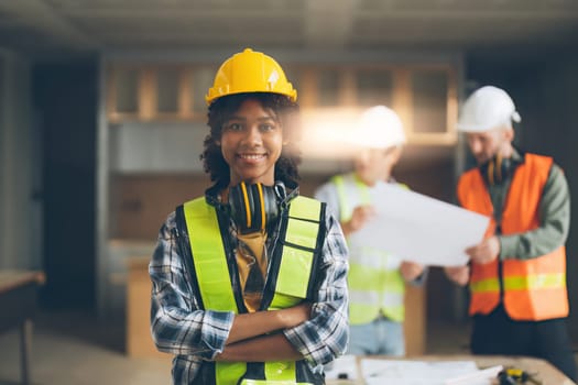 Foreman builder woman at construction site. American African foreman construction standing at construction site.