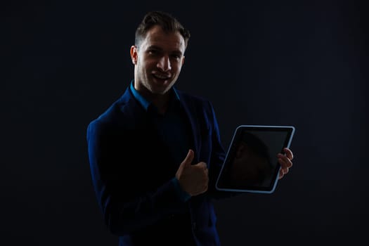 business, people and future technology concept - close up of businessman with tablet pc computer over black.