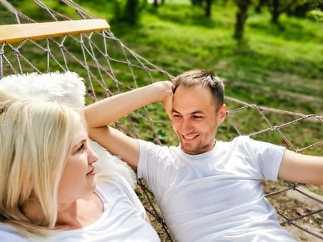 Mid adult couple relaxing in hammock.