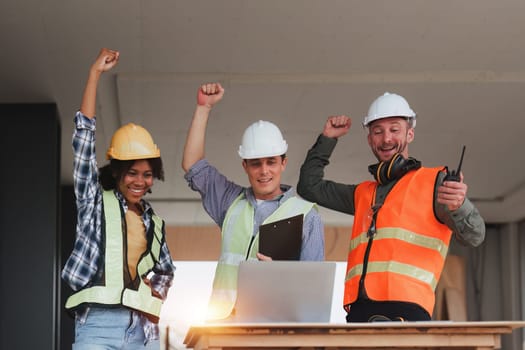 Engineer and Architecture and Foreman celebrate success at construction site. Industrial people and manufacturing labor concept.