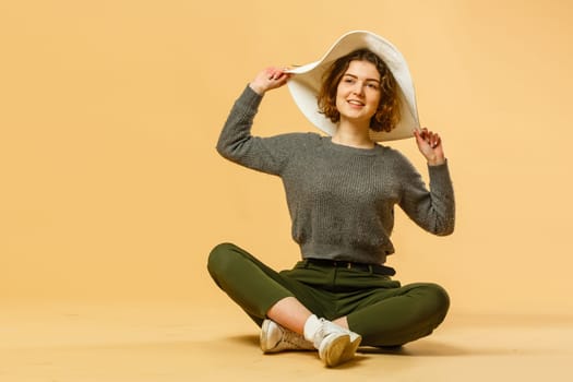 Traveler tourist woman on orange background. Passenger traveling abroad to travel on weekends getaway. Air flight journey concept.