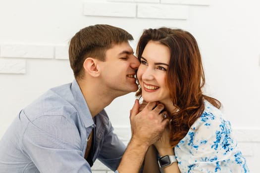 happy young couple have fun and relax in their new big bright home apartment