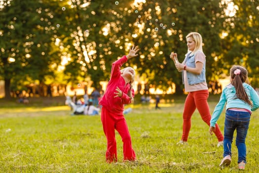 Two young Caucasian girls blowing bubbles.