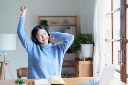 Portrait of young woman showing fatigue from studying online at home.