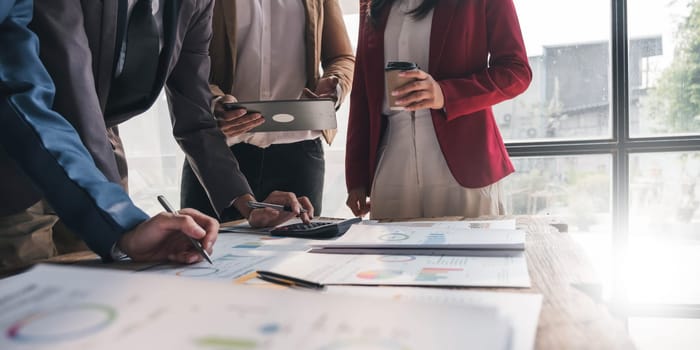 Business People Meeting using laptop computer,calculator,notebook,stock market chart paper for analysis Plans to improve quality next month. Conference Discussion Corporate Concept....