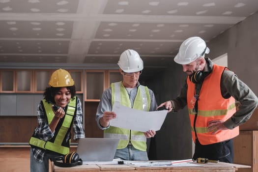 Civil engineer teams meeting working together wear worker helmets hardhat on construction site in modern city. Foreman industry project manager engineer teamwork. Asian industry professional team...