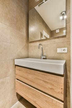 a bathroom with a sink and mirror in the wall above it that is made out of wood planks on the floor