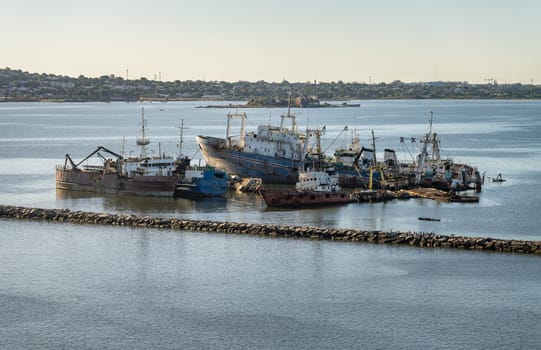 Abandoned ships rusting in shallow water in the harbor of Montevideo in Uruguay