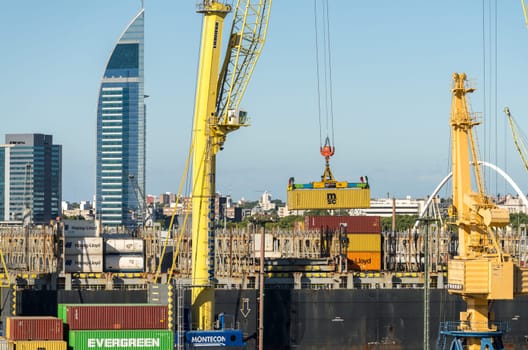 Montevideo, Uruguay - 5 February 2023: Containers being loaded onto ship in commercial port